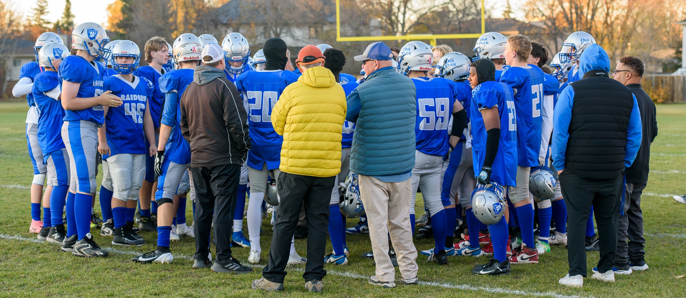 Oak Park team huddle with coaches looking on