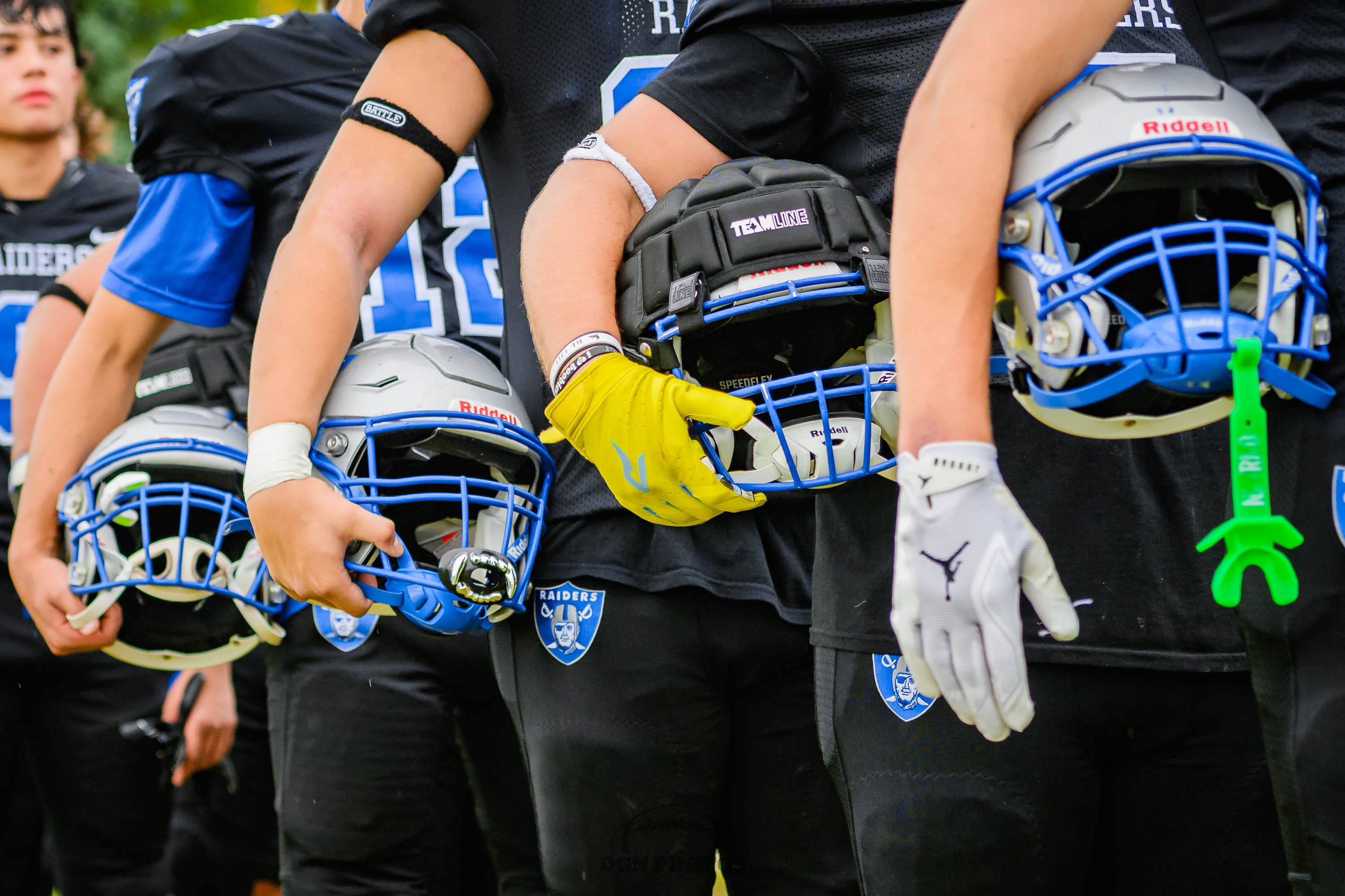 Oak Park Players holding their helmets